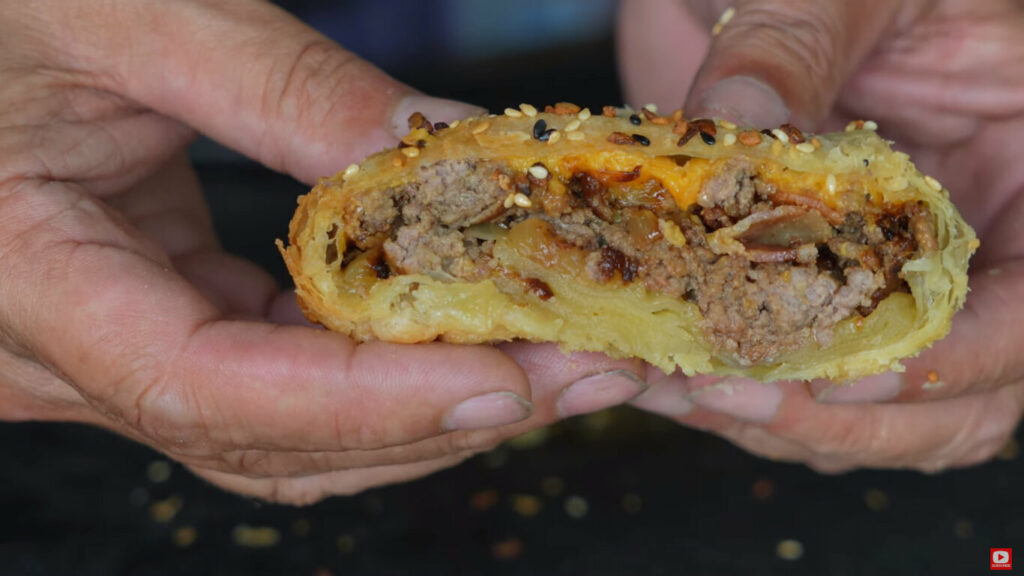 Finished bacon burger bomb sliced open to show interior